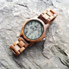 WILD ROCK RK10G – Koa wood watch with gray marble dial on a stone background